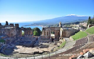 The photo shows the beautiful ancient Greek-Roman theater of Taormina overlooking the Ionian sea and Mount Etna on a beautiful sunny day - Geo Etna Explorer - Eastern Sicily Tour, Taormina, Catania, Syracuse and Mount Etna, excursions and tours private and group