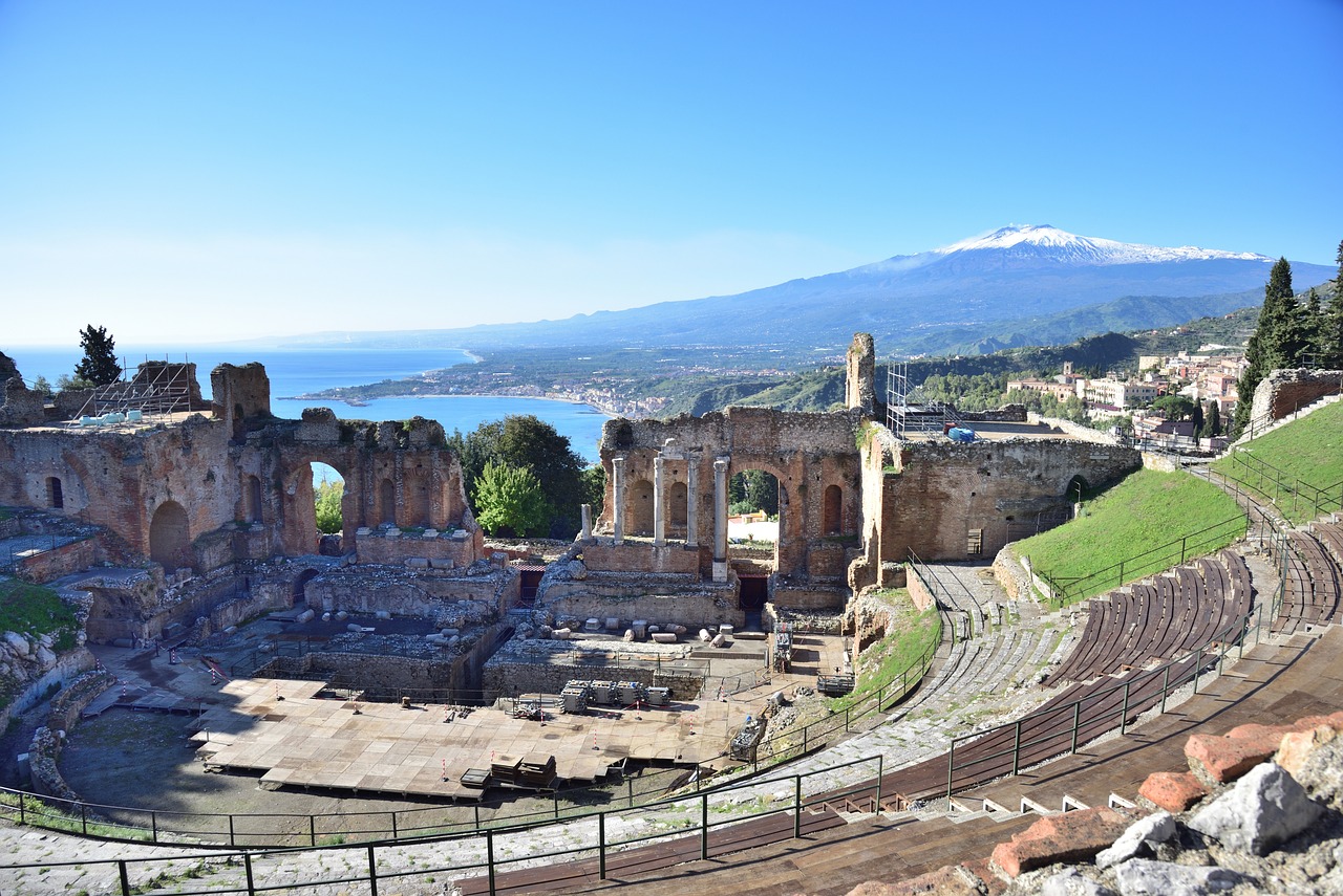 The photo shows the beautiful ancient Greek-Roman theater of Taormina overlooking the Ionian sea and Mount Etna on a beautiful sunny day - Geo Etna Explorer - Eastern Sicily Tour, Taormina, Catania, Syracuse and Mount Etna, excursions and tours private and group